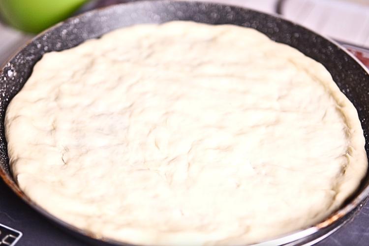 Transfer the dough onto a pizza stone, round fry pan or a suitable baking tray